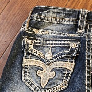 Rock Revival Distressed Dark Blue Cropped Jeans with Embellished Pocket